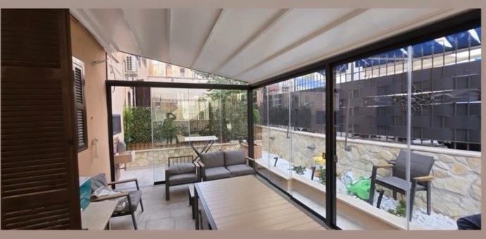 Veranda chiusa con vetrate trasparenti, vista dall'interno